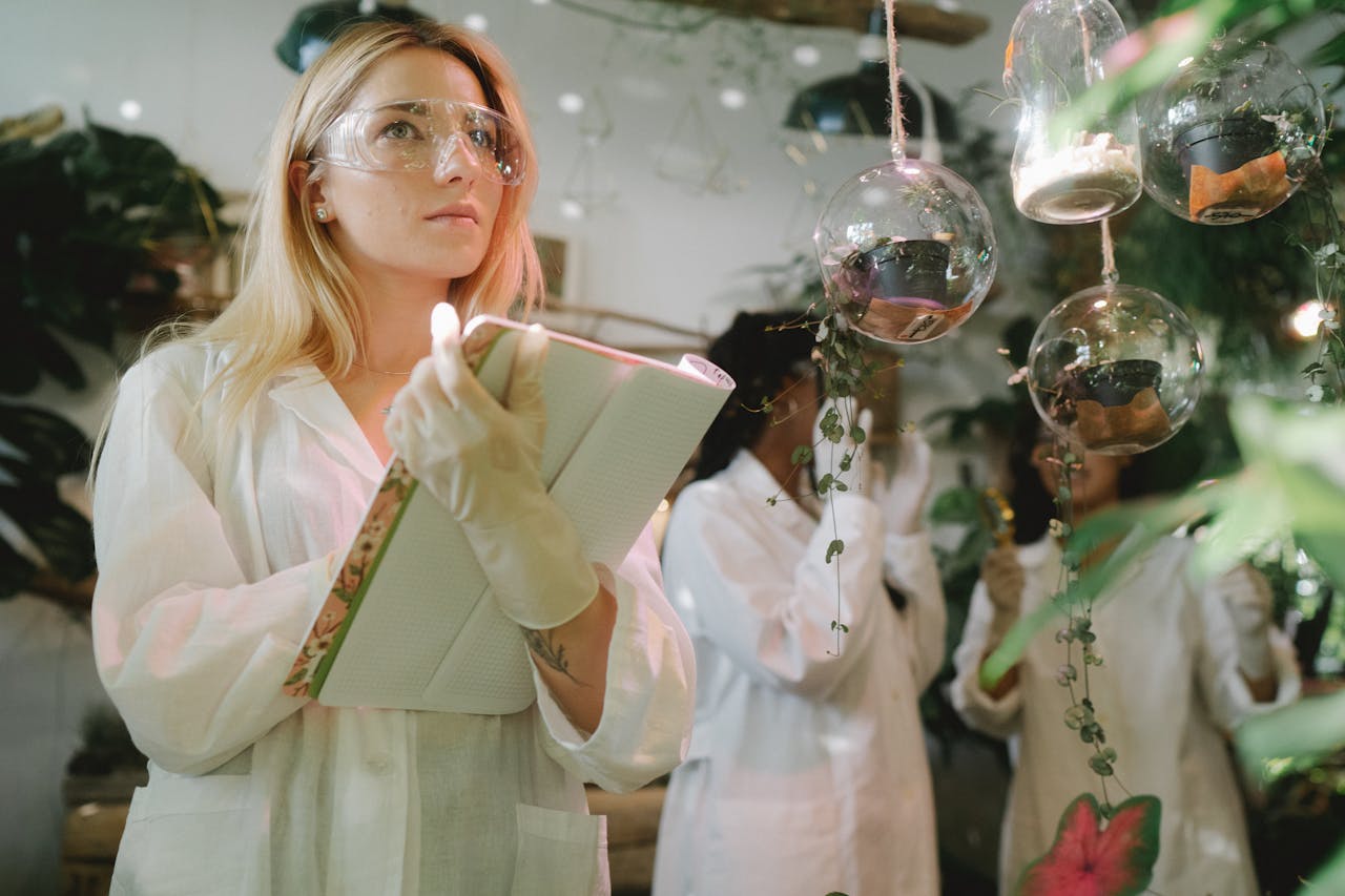 Female scientist observing plant experiments in a lab setting.